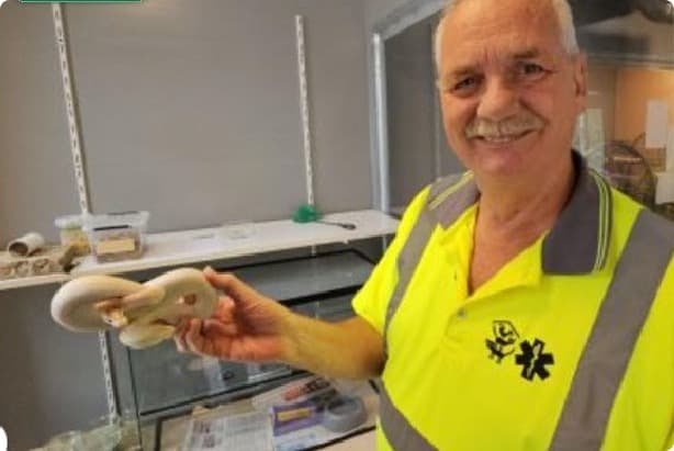 Een medewerker van de dierenambulance met de slang - Dierenzorgcentrum Louterbloemen