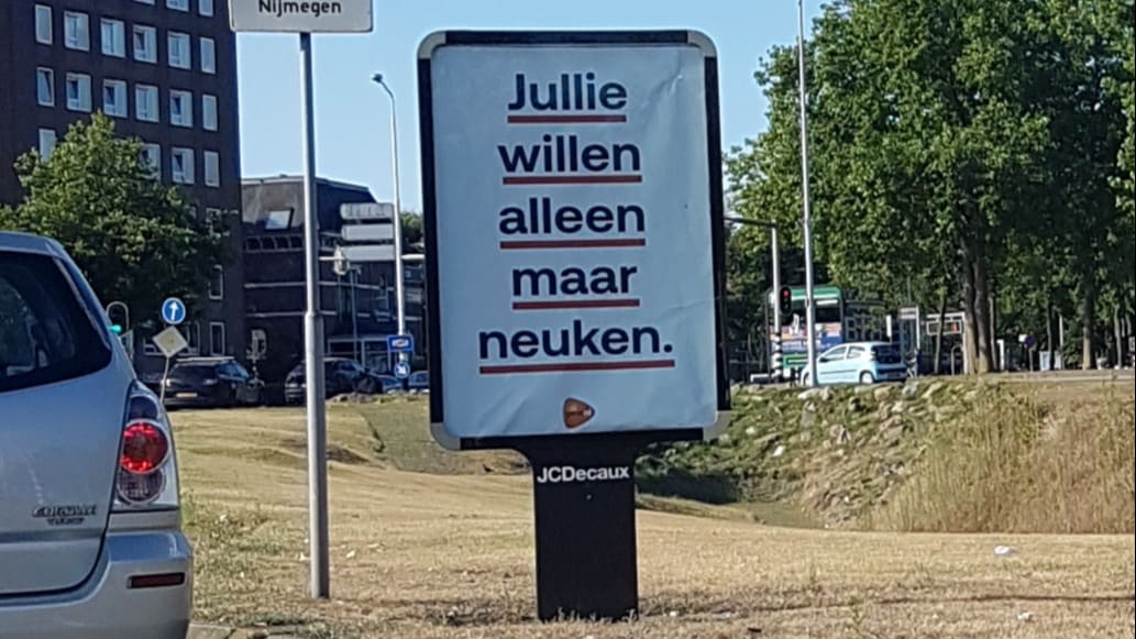 PostNL 'not amused' door schunnige posters met bedrijfslogo in Nijmegen 
