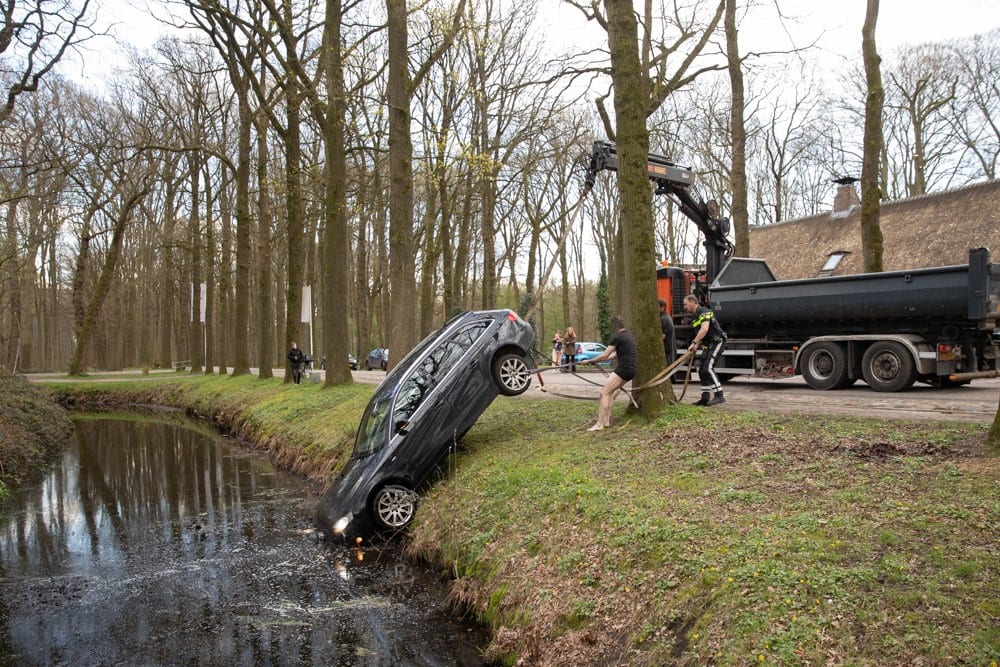 Man vergeet handrem en ziet hoe auto in de gracht rolt
