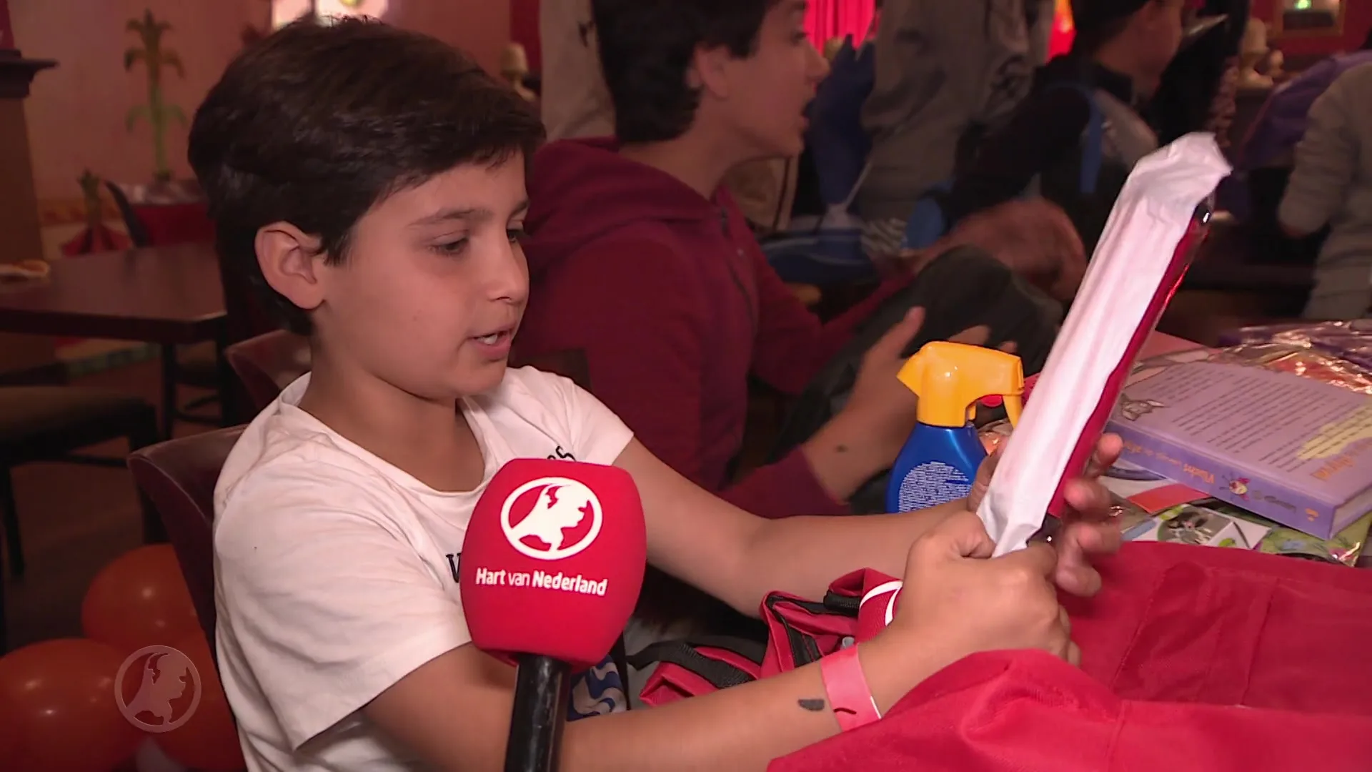 Kinderen in armoede ontvangen rugzak met zomerpret