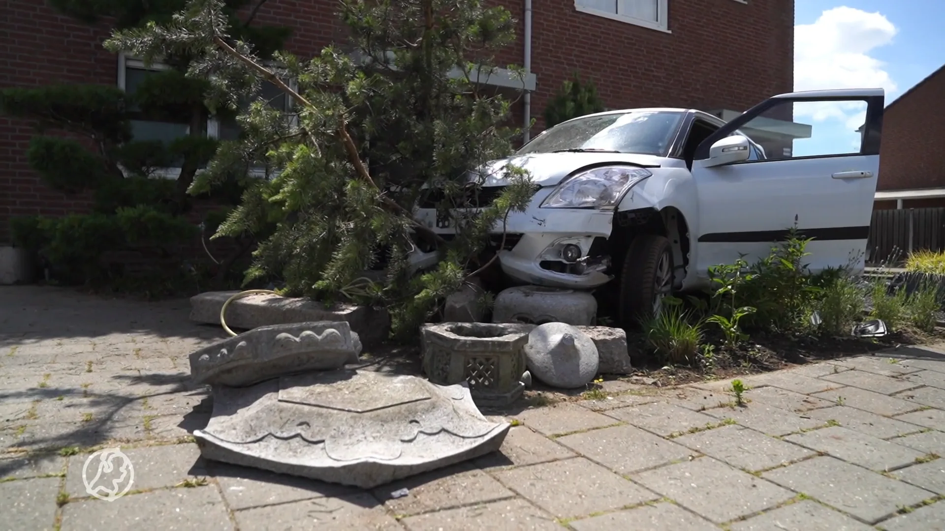 Geschrokken automobilist rijdt door garage, voortuinen en speeltuin en laat ravage achter