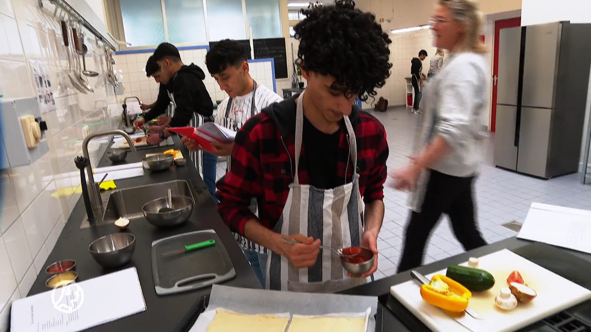 Vluchtelingen leren de Nederlandse taal door samen te koken