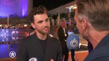 Songfestivalartiesten flaneren over oranje loper