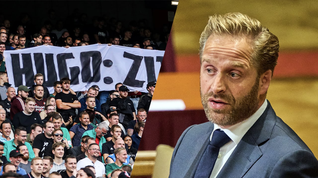 Feyenoord-supporters tonen spandoek en zingen aanwezige Hugo de Jonge toe