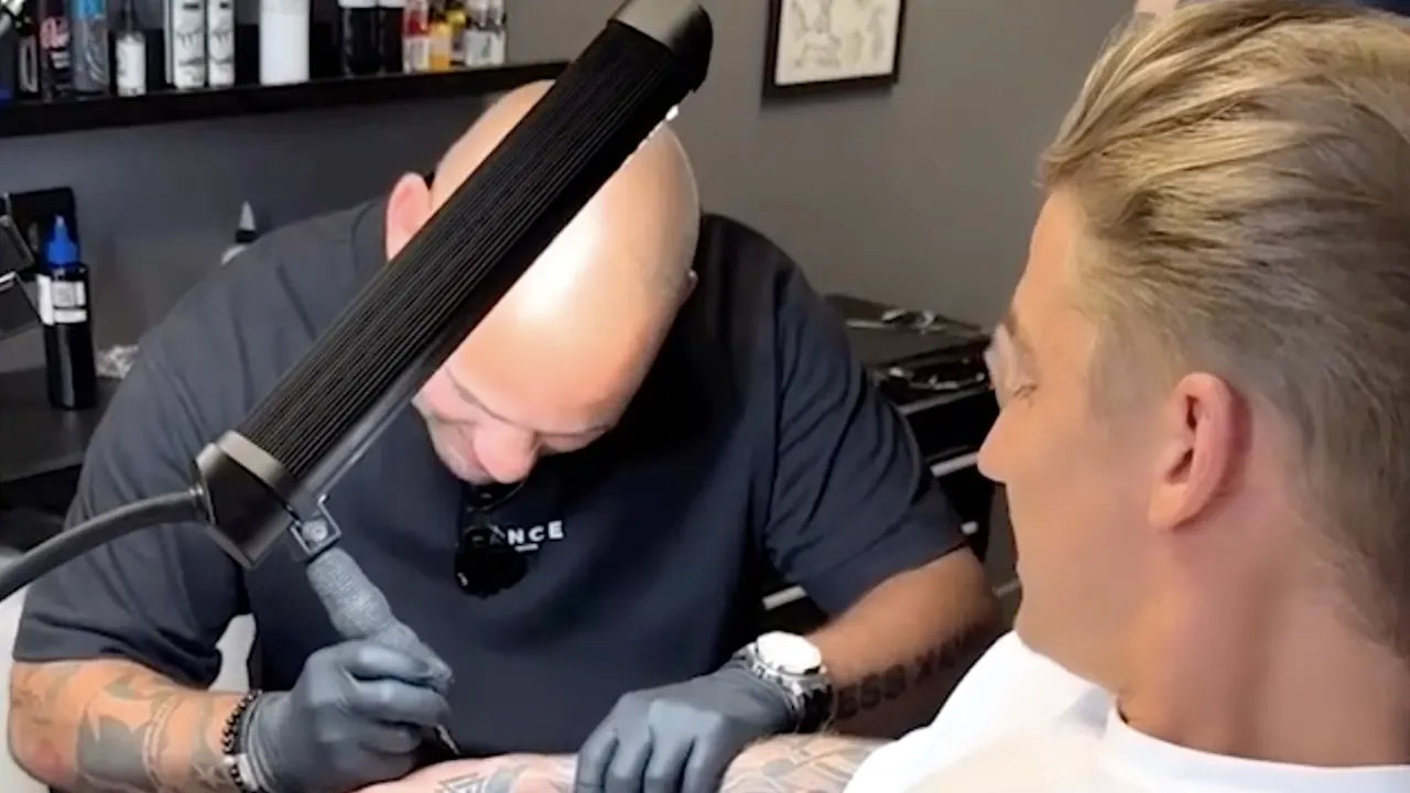Wesley Sneijder zet handtekening als tatoeage op Mart Hoogkamer