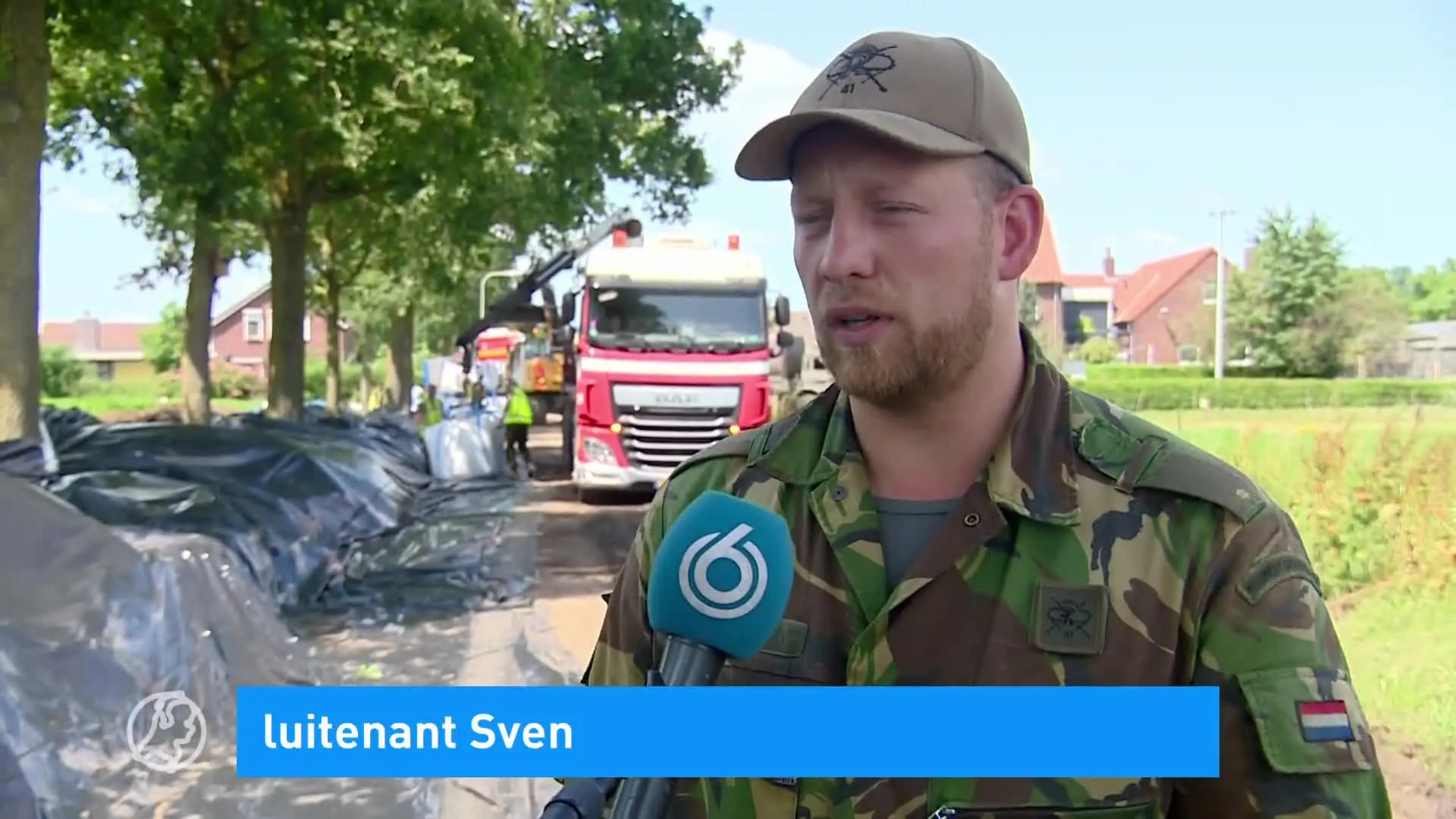 Militairen en vrijwilligers slaan handen ineen om nooddijk in Well te bouwen