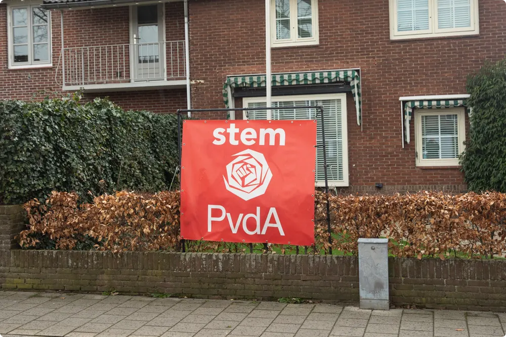 Na de bekladding van het spandoek met zijn gezicht heeft Eijbaard het laten vervangen door een PvdA-banner. Beeld: Caspar Huurdeman